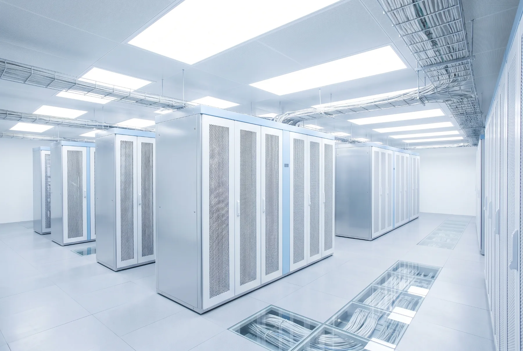 Rows of pale server cabinets in a bright machine room